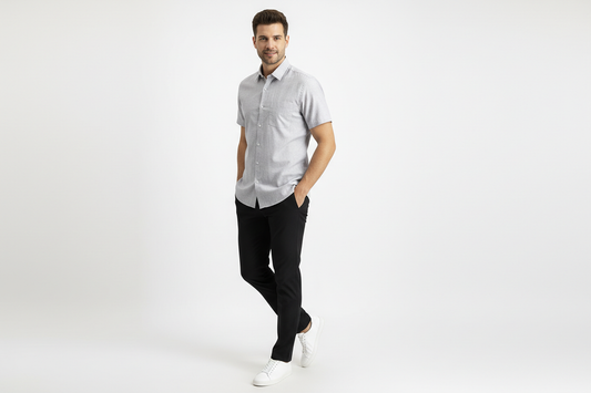 Full body shot of photo realistic portrait of a stylish male model wearing a vibrant () short-sleeve formal shirt without pocket , slim-fit black pants, and crisp white minimalist sneakers, detailed clothing texture, studio lighting, clean background, full color, standing casually with hands in pockets, one leg slightly bent, confident relaxed expression, slight side angle to show outfit flow, dynamic pose#D5D6D5
